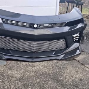/=== PASTE EVERYTHING BELOW INTO YOUR WORDPRESS EDITOR ===/ 2016-2023 Camaro Front Bumper with Carbon Fiber Splitter – ZL1 Style | Complete Assembly — PRODUCT OVERVIEW Transform your 6th generation Camaro with this complete front bumper assembly featuring an aggressive ZL1 style design and a real carbon fiber front splitter. This package gives your LS, LT, RS, or SS the track-inspired look of the ZL1 without the factory ZL1 price tag. The bumper features the iconic ZL1 styling with larger grille openings and aggressive lines, while the carbon fiber splitter adds a premium, race-ready touch. The splitter is made from authentic carbon fiber with a high-gloss UV-protected finish. The complete package is designed to bolt directly to your Camaro using factory mounting points. — WHAT'S INCLUDED This complete package includes: **Front Bumper:** • (1) ZL1 Style Front Bumper Cover – Unpainted polypropylene • Aggressive ZL1 design with larger grille openings • Factory-style mounting points **Carbon Fiber Splitter:** • (1) Real Carbon Fiber Front Splitter – 2x2 twill weave • High-gloss UV-protected clear coat • Pre-drilled mounting holes **Hardware:** • Mounting hardware for splitter installation ❌ Does NOT Include: - Grilles (sold separately) - Fog lights or bezels - Impact absorber (transfer from existing) - Paint (professional painting required) — CONDITION DETAILS **Front Bumper:** ✅ Brand New – Never installed ✅ ZL1 Style – Aggressive design ✅ Polyurethane Construction – Durable, flexible ✅ Unpainted – Ready for custom color ✅ All Mounting Points Intact – Factory tabs **Carbon Fiber Splitter:** ✅ Brand New – Real carbon fiber ✅ High-Gloss Finish – UV-protected clear coat ✅ Perfect Condition – No scratches or damage ✅ Pre-drilled – Ready for installation Please review all photos carefully – they are part of the description. — KEY FEATURES 🔧 Complete Package – Bumper and carbon splitter included 🔧 ZL1 Aggressive Styling – Track-inspired appearance 🔧 Real Carbon Fiber Splitter – Authentic 2x2 twill weave 🔧 UV-Protected Clear Coat – Prevents yellowing and fading 🔧 Direct Fit – Uses factory mounting points 🔧 Fits 2016-2023 Camaro – LS, LT, RS, SS, LT1 🔧 Durable Polypropylene – Same material as factory bumpers 🔧 Professional Installation Recommended — VEHICLE FITMENT ✅ Compatible Models (2016-2023): - 2016-2023 Chevrolet Camaro LS - 2016-2023 Chevrolet Camaro LT - 2016-2023 Chevrolet Camaro RS - 2016-2023 Chevrolet Camaro SS - 2020-2023 Chevrolet Camaro LT1 ✅ Compatible Trims: - All non-ZL1 6th Gen Camaro coupe models ❌ Does NOT Fit: - Camaro ZL1 (already has ZL1 front end) - 2016-2018 Camaro with factory ZL1 - Convertible models (verify fitment) ⚠️ **Important Fitment Notes:** - This bumper is designed for 2016-2023 non-ZL1 models - Grilles, fog lights, and bezels are sold separately - Professional installation recommended — CARBON FIBER SPLITTER DETAILS The included carbon fiber splitter features: 🏁 **Real Carbon Fiber Construction:** Authentic 2x2 twill weave – not hydro dipped or wrapped 🏁 **High-Gloss UV-Protected Clear Coat:** Prevents yellowing and fading from sun exposure 🏁 **Aggressive Design:** Extends forward for a lower, more aggressive stance 🏁 **Lightweight:** Significant weight savings over plastic or fiberglass 🏁 **Pre-Drilled:** Mounting holes ready for installation 🏁 **Track-Inspired:** Complements the ZL1 style bumper perfectly — INSTALLATION INFORMATION ⚠️ **PROFESSIONAL INSTALLATION STRONGLY RECOMMENDED** ⚠️ **Front Bumper Installation Time:** 3-5 hours **Splitter Installation Time:** 30 minutes **Difficulty Level:** Moderate to Advanced **Installation Overview:** 1. Remove front wheels and wheel well liners 2. Remove factory fasteners along bottom and top of bumper 3. Disconnect wiring for sensors, fog lights, and DRLs 4. Remove factory bumper assembly 5. Transfer grilles, fog lights, and sensors (may need ZL1 specific parts) 6. Test fit ZL1 style bumper (DO THIS BEFORE PAINTING) 7. Prep and paint bumper (professional required) 8. Install carbon fiber splitter to bumper 9. Install new ZL1 style bumper 10. Reconnect all wiring 11. Align and secure all fasteners 12. Reinstall wheel liners and wheels **Tools Needed:** - Socket set (7mm, 10mm) - Trim removal tools - Ratchet and extensions - Drill (for splitter installation) - Second person for assistance ⚠️ **Important:** Professional painting and installation strongly recommended for best results. — PAINTING INFORMATION The bumper comes **UNPAINTED** and requires professional painting: **Recommended Process:** 1. Test fit BEFORE painting – critical for aftermarket bumpers 2. Sand/scuff raw polypropylene surface 3. Apply adhesion promoter (required for polypropylene) 4. Apply primer 5. Paint to match your factory color code 6. Clear coat for protection **Common 2016-2023 Camaro Color Codes:** - GBA – Summit White - G9K – Black - G7C – Red Hot - GKO – Riverside Blue - G1E – Shadow Gray - GXH – Hyper Blue - GAZ – Satin Steel - GXN – Rapid Blue - GMO – Wild Cherry Tintcoat **Professional painting is REQUIRED** – do not attempt to paint without proper adhesion promoter. — WHY BUY THIS COMPLETE PACKAGE? Buying the bumper and carbon splitter together offers several advantages: ✅ **Save Money:** Package pricing is less than buying separately ✅ **Perfect Match:** Splitter designed specifically for this bumper ✅ **Complete Solution:** Everything in one shipment ✅ **One Shipping Cost:** Combined shipping saves money ✅ **Ready to Install:** Both components ready for paint and installation — WHAT YOU WILL NEED FOR COMPLETE INSTALLATION To complete your ZL1 front end conversion, you will need: **Required (Not Included):** - ZL1 Style Upper Grille - ZL1 Style Lower Grille - ZL1 Style Fog Light Bezels - Professional Paint and Prep **Recommended (Not Included):** - ZL1 Emblem - ZL1 Specific Impact Absorber (may need modification) **Transfer from Your Factory Bumper:** - Wiring harnesses - Parking sensors (if equipped) - Front emblem (if not using ZL1 emblem) — FREQUENTLY ASKED QUESTIONS **Will this fit my 2020 Camaro SS?** Yes, this bumper fits all 2016-2023 Camaro LS, LT, RS, SS, and LT1 models. **Will this fit my 2018 Camaro?** Yes, fits 2016-2023 models – all years. **Is the splitter real carbon fiber?** Yes – authentic real carbon fiber with UV-protected clear coat. **Does this come painted?** No, the bumper is unpainted and requires professional painting. **Do grilles come with this bumper?** No, ZL1 style grilles are sold separately. **Does the splitter come with hardware?** Yes, splitter mounting hardware is included. **Will my factory fog lights fit?** This bumper is designed for ZL1 style fog light bezels. You may need ZL1 specific fog lights or bezels. **Can I install this myself?** Professional installation is strongly recommended for proper fitment and alignment. **Is this the ZL1 1LE style?** This is the standard ZL1 style bumper. The splitter adds aggressive 1LE-inspired styling. **What about the front camera?** If your vehicle has a front camera, you may need to transfer it or purchase a ZL1 specific camera bracket. **Can I see more photos?** Absolutely – contact us and we're happy to provide additional photos. **What's the return policy?** Returns accepted within specified timeframe on unpainted, unmodified bumpers. Contact us for complete return policy details. — COMPLETE YOUR ZL1 CONVERSION Pair this front bumper and splitter with: • ZL1 Style Upper Grille • ZL1 Style Lower Grille • ZL1 Style Fog Light Bezels • ZL1 Emblem • ZL1 Style Side Skirts • ZL1 Style Rear Spoiler — SHIPPING INFORMATION Processing Time: 1-3 business days Shipping Method: Freight / LTL truck Delivery Time: 3-10 business days The bumper and splitter are carefully packaged together to prevent damage during transit. Inspect immediately upon delivery. Local pickup is welcome – contact us to arrange. — ORDER YOUR CAMARO FRONT BUMPER WITH CARBON SPLITTER TODAY Transform your 2016-2023 Camaro LS, LT, RS, or SS with this complete front bumper assembly featuring an aggressive ZL1 style design and real carbon fiber splitter. The ultimate front end upgrade! Questions about fitment or installation? Contact our Camaro specialist team for expert assistance! /=== EXTERNAL RESOURCES === For installation guides and ZL1 conversion tips, check Camaro6 Forums where owners share their front end conversion experiences.